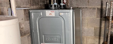 Technician servicing an oil furnace and boiler system